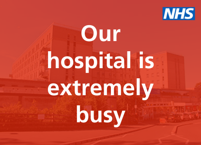 Red alert with our hospital is very busy written on it in front of a picture of Derriford