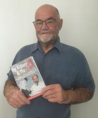 Andy Demaine with his book