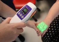 Vein finder equipment lighting up arm showing veins