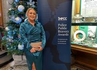 Gemma Wellman, a Renal Transplant Nurse Specialist at UHP, in front of a promotional banner at the Police Public Bravery Award ceremony