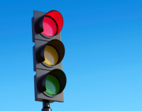 an image of a traffic light against a blue sky